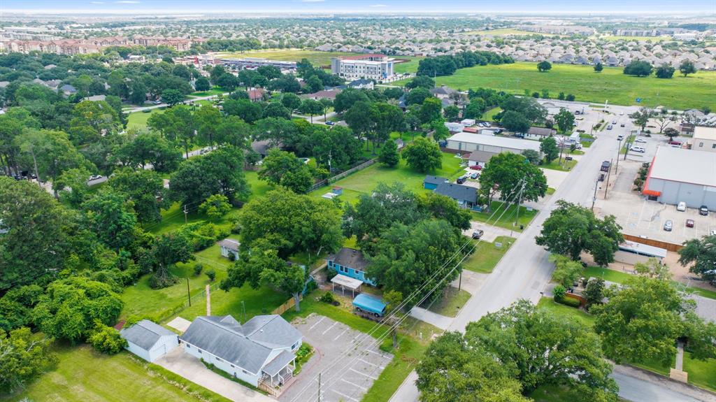 View showing intersection of East 5th and Katy Ft. Bend Rd. as well as other businesses nearby.