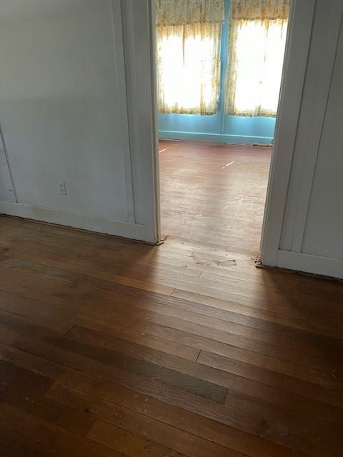 View of wood flooring from living room into front bedroom. Sellers removed the carpet and floors are original to home and in good condition.