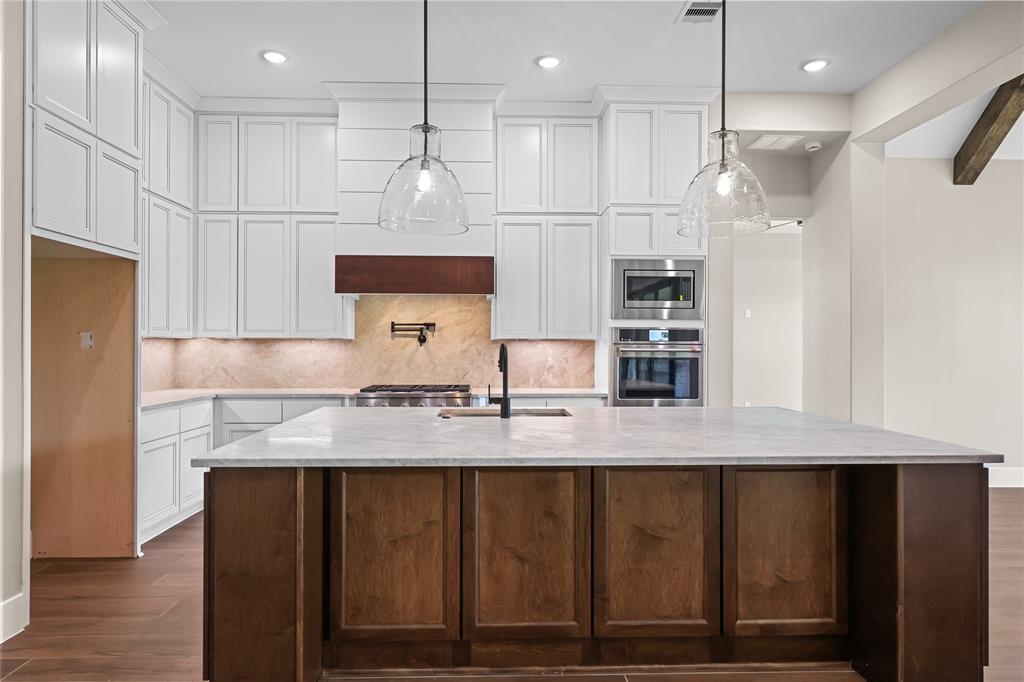 Updated picture as of May 25th: Amazing chef’s kitchen includes an island with seating and cabinets that extend all the way up to the ceiling for maximum storage.