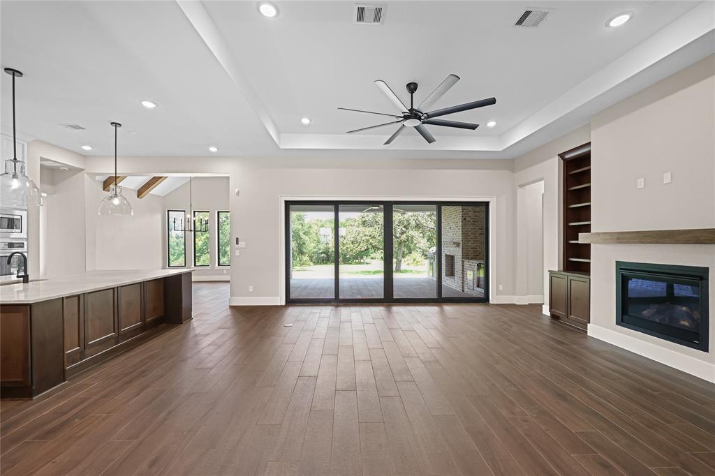 Reverse view of the light and bright entry with the study in the front of the home. We will be adding glass doors to this space to make this home truly a modern farmhouse. Hallway leads to another bedroom and en-suite bathroom.