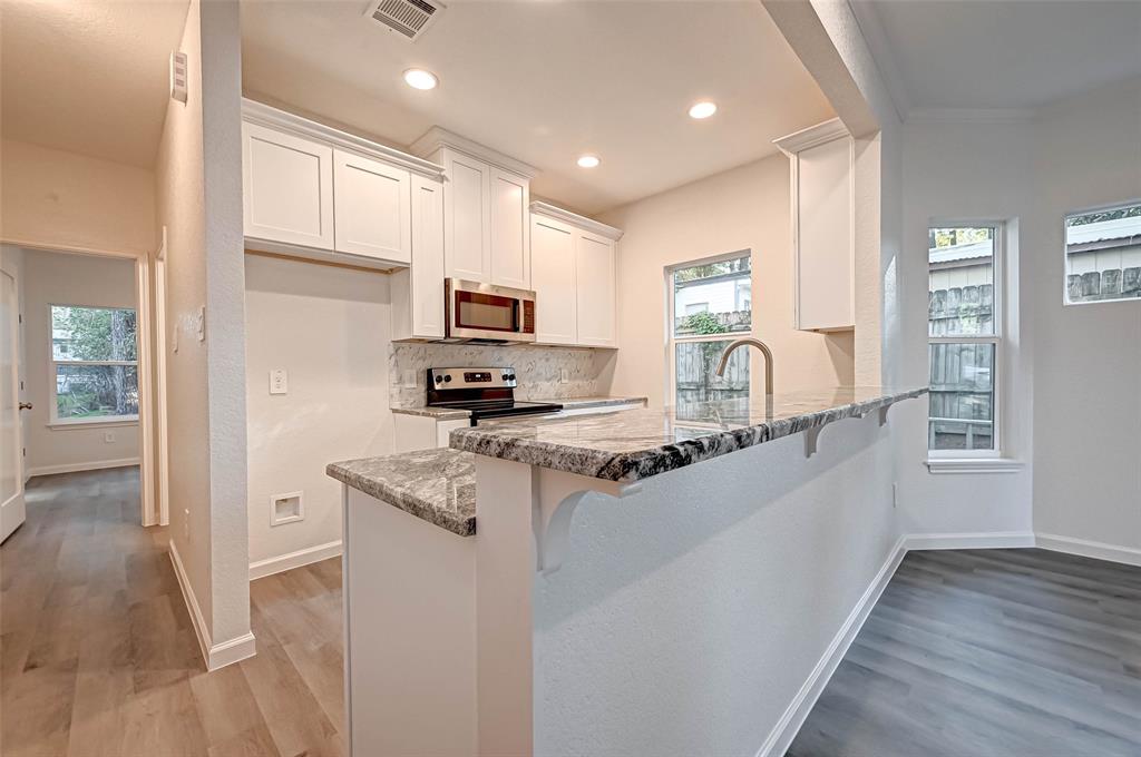 Granite Countertops and convenient Kitchen Bar.