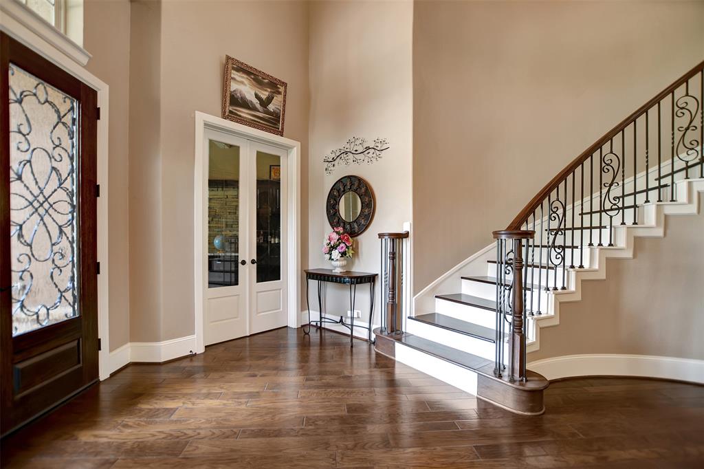 Dramatic entry with curved stairway , wrought iron spindles  and wood treads