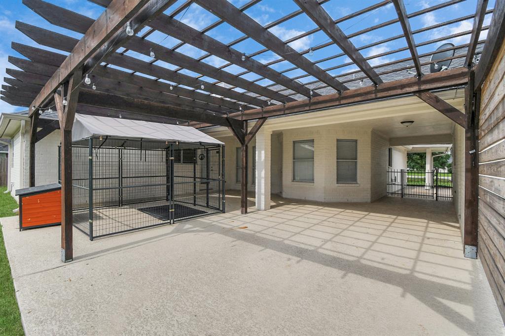 Covered back patio with pergola and privacy wall