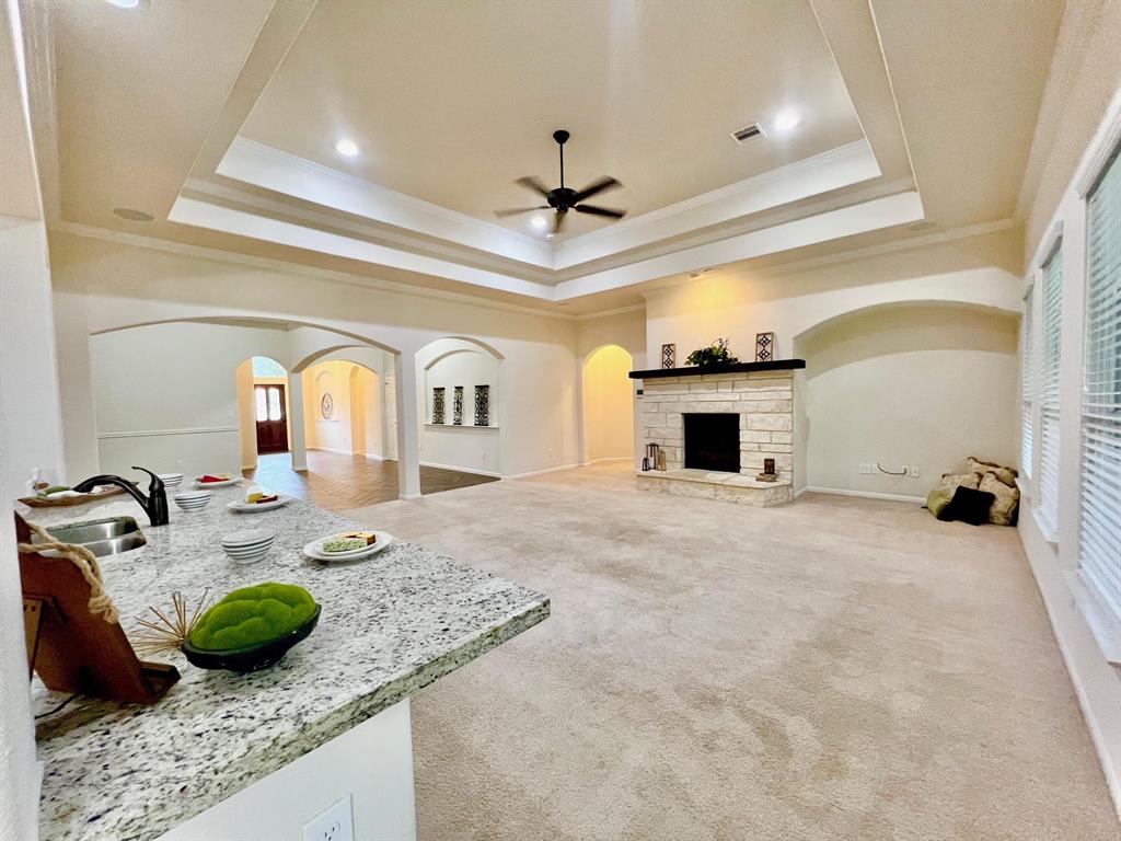 The stone surround on the fireplace. The primary bedroom entrance is to the left.