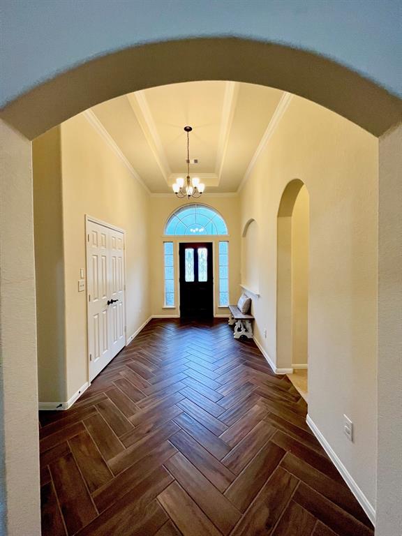 The entrance offers a beautiful, wood tile herringbone pattern.