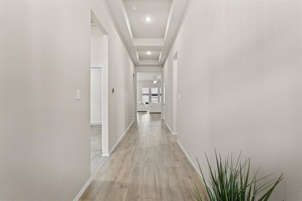 Upon entry, you’ll be greeted with beautiful 12-ft. coffered ceilings and a wide entry way!