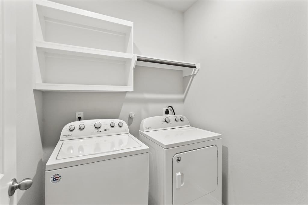 Spacious laundry room with shelves for storage