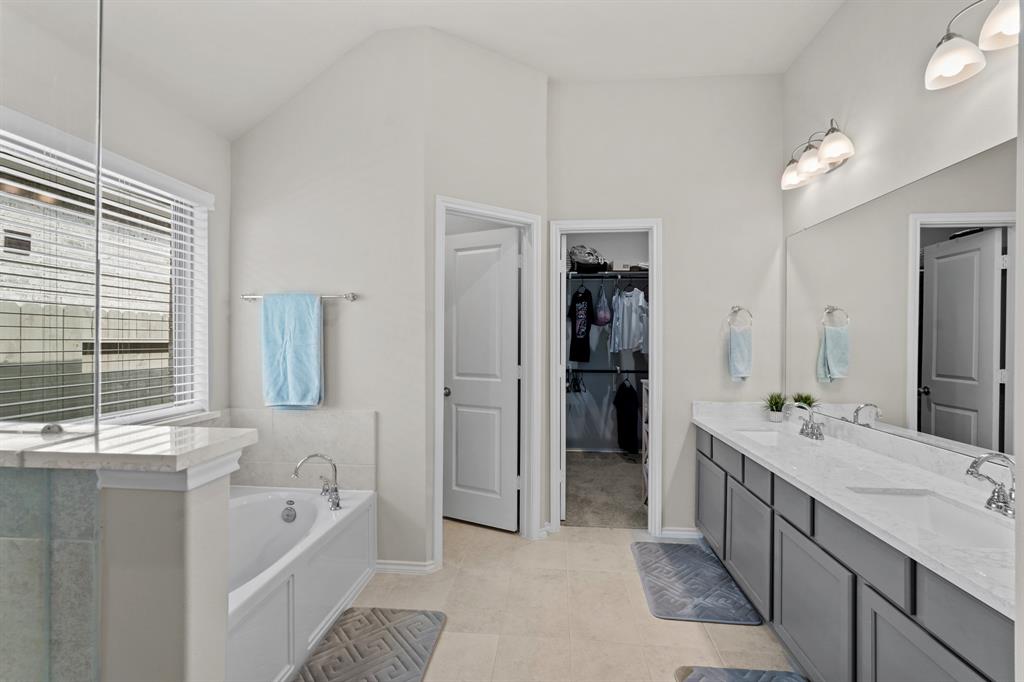 12x11 - Primary bathroom with dual vanity sinks provides plenty of space for two