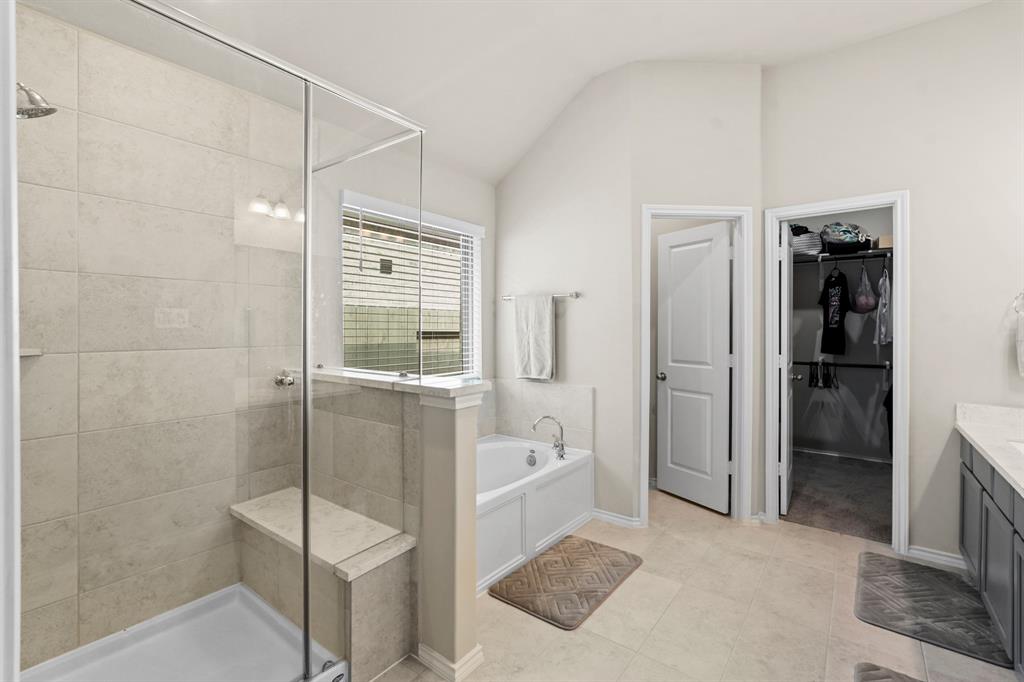 Spacious walk in shower with seating bench