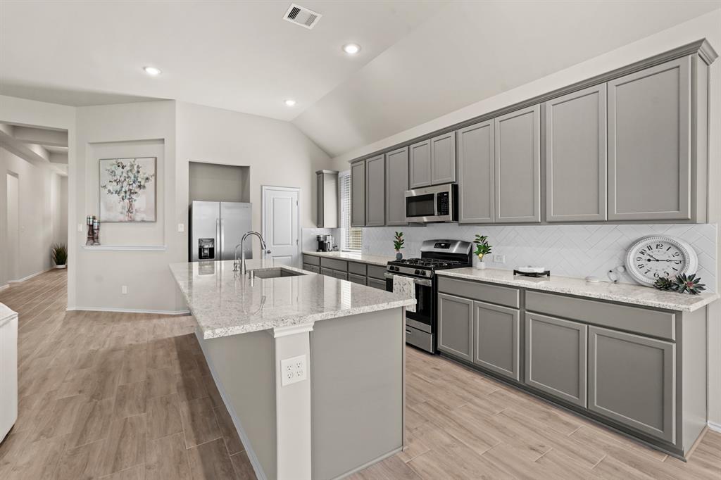 This is truly the heart of the home! This kitchen was designed for any chef to enjoy cooking and entertaining with a walk-in pantry and so much natural lighting!