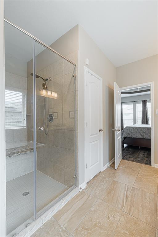 Separate walk-in shower with seat.