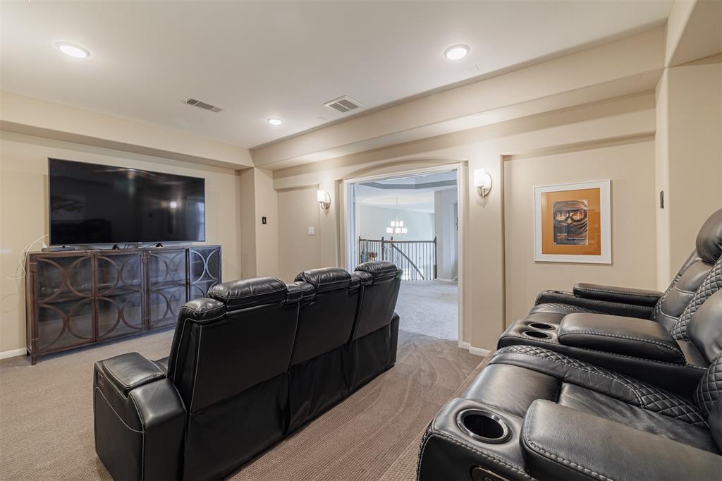 Another view of the media room looking through the double doors towards the game room.