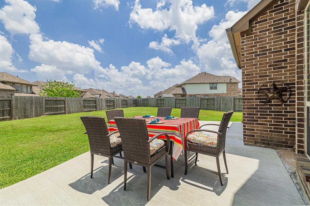 Extended back patio overlooking the large backyard.