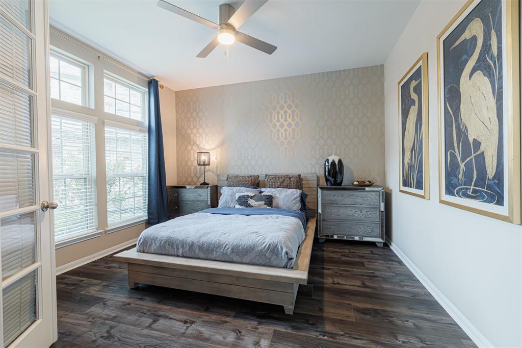 The study off the foyer is currently being used as a guest bedroom. It features double French doors, wall of windows and luxury vinyl plank flooring.