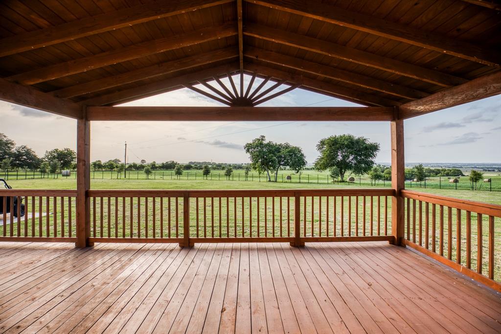 The front deck of Jamila Olive Orchard serves as a warm and welcoming entrance to this charming home. Crafted from rich, sturdy wood, the deck exudes rustic elegance while providing a practical space for outdoor enjoyment. This serene spot is ideal for morning coffee or evening relaxation, offering picturesque views of the surrounding greenery.