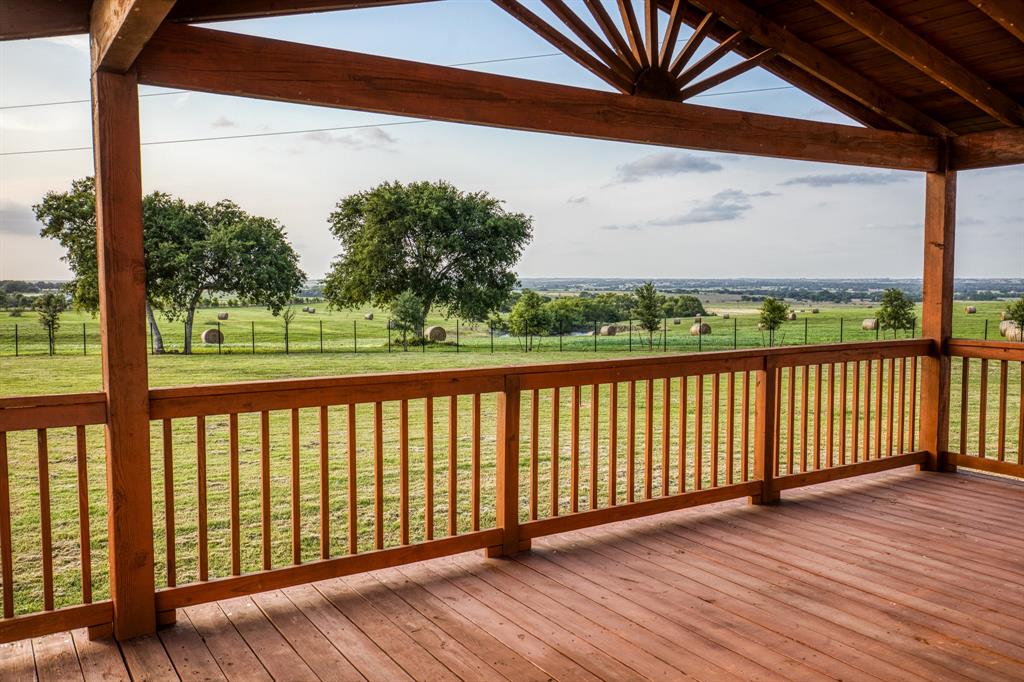 Covered by a striking wooden pergola, the deck provides shade and a touch of architectural flair, making it perfect for all-weather enjoyment.