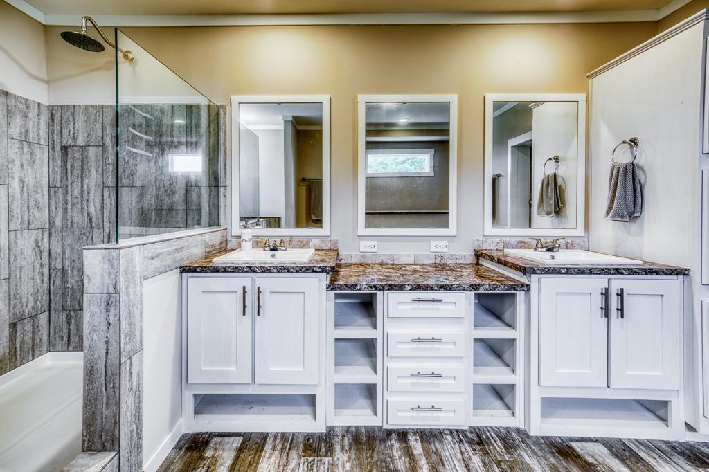 The en-suite bathroom is a luxurious sanctuary, featuring a deep soaking tub, a spacious walk-in shower, and dual vanities with ample storage.