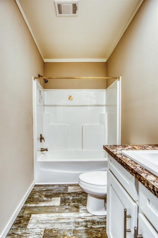 The sleek, white bathtub is the focal point, providing a perfect place to unwind and relax.