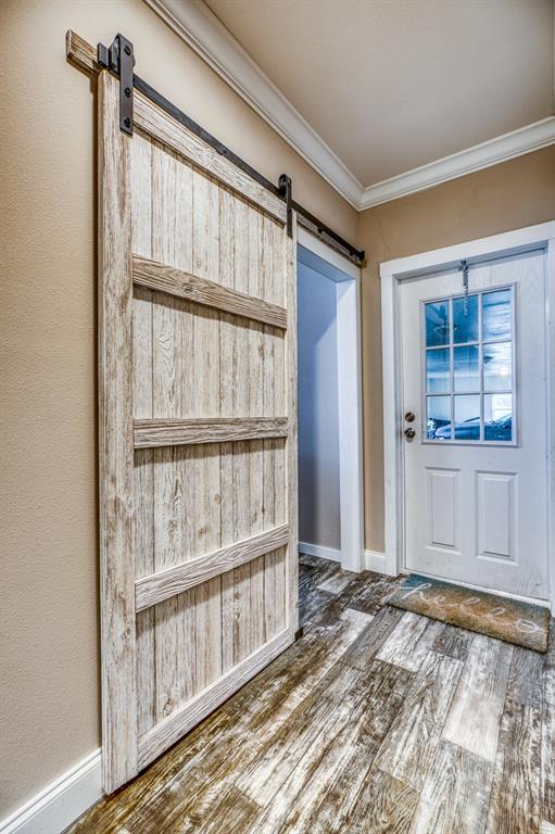 Featuring a charming rustic sliding barn door, this area exudes a cozy, farmhouse charm.