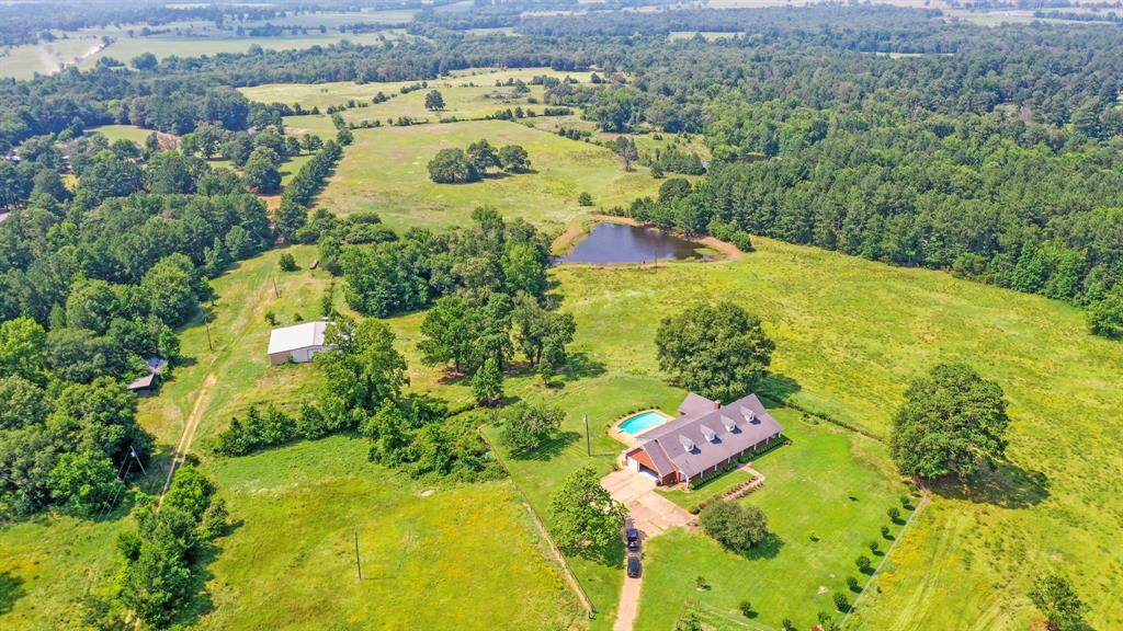 This one of a kind acreage property offers a lifestyle that cannot be replicated.Situated on over 109 undulating acres, this stately 4459 SF home is almost entirely on one floor, & sits on the highest point of the property offering gorgeous views of the rolling terrain.Spacious island kitchen offers tons of space for entertaining your family & guests.Two large pantries & tons of counter & cabinet space provide ample storage.Huge laundry/mud room with sink & lots of storage.Oversized 3 car garage, plus lots of paved parking.Convenience is at your fingertips, with HEB & Walmart about 2 miles away, & restaurants & world class BBQ close by.60x40 barn w/double overhangs for your equipment & toys.5 stock ponds have always stayed wet regardless of drought level, & 3 offer big largemouth bass & bluegill.Lots of whitetail;property has not been hunted in decades.Electricity in several additional spots offers options.City water & deep well.80 Miles from The Woodlands.Most furnishings negotiable.