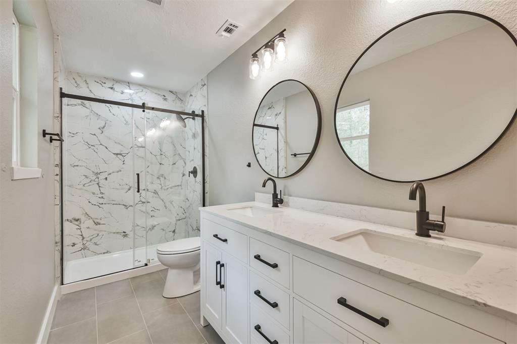 The ensuite bath features an amazing shower with sliding glass doors and double sinks!