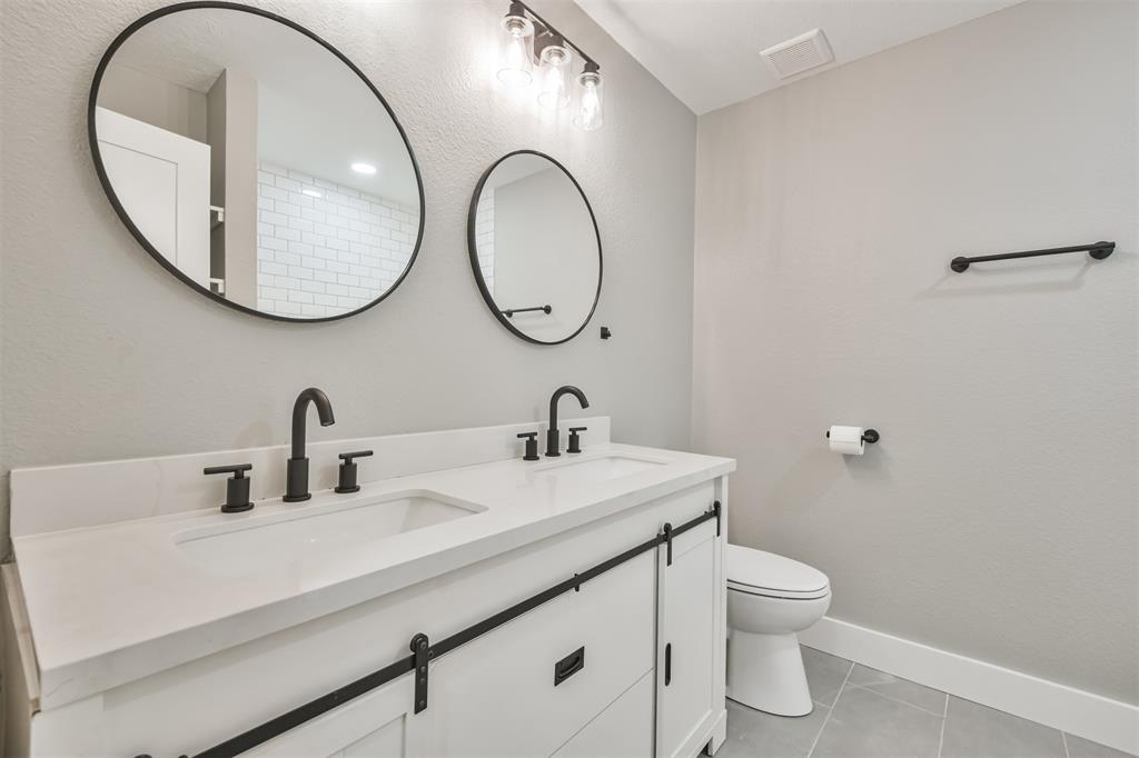 Double sinks in the secondary bath! Notice the sliding barn door style cabinet doors!