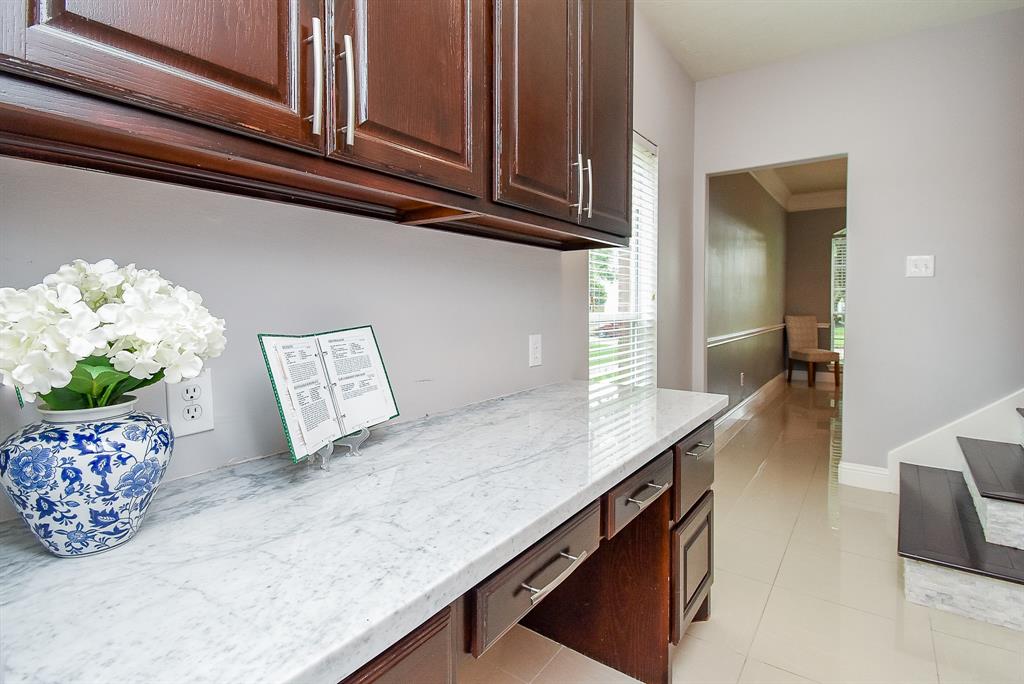 A second staircase makes this kitchen area so appealing; including this sleek butler\'s pantry --- an invaluable feature, especially when entertaining. It\'s also that kind of catch-all space that lends itself to every lifestyle need.