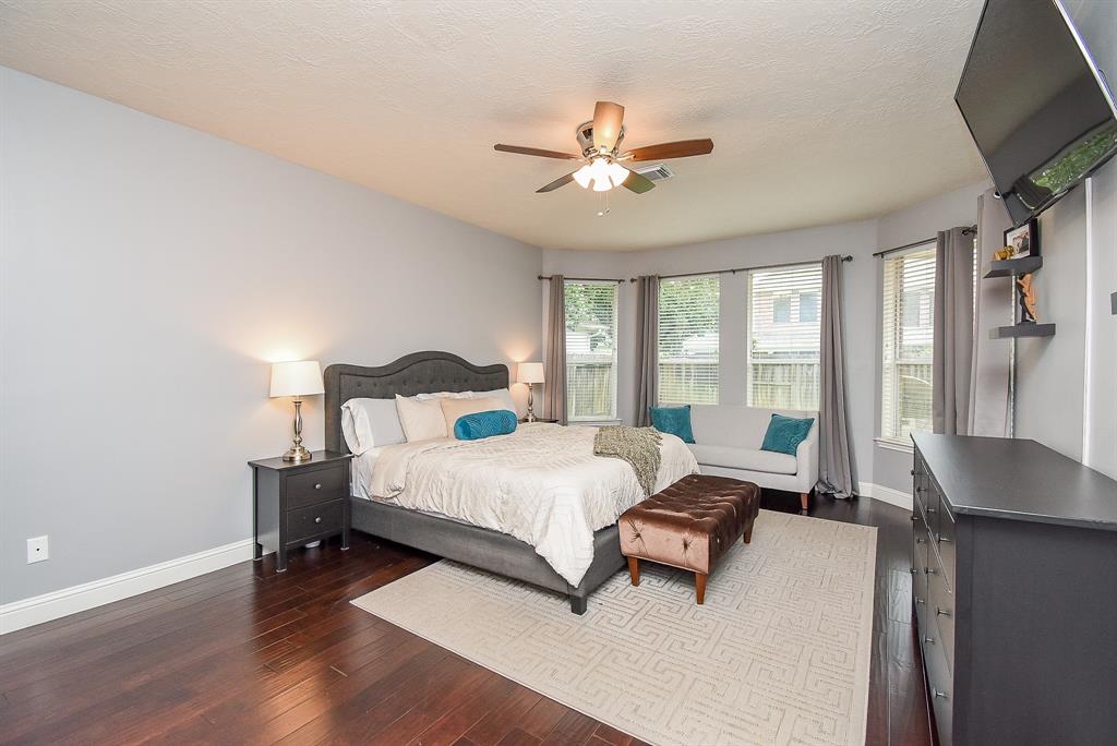 This elegant primary ensuite bedroom/bath offers splendid room for furnishings, accents, and maybe for the creation of a cozy reading nook under the lovely windowed wall.