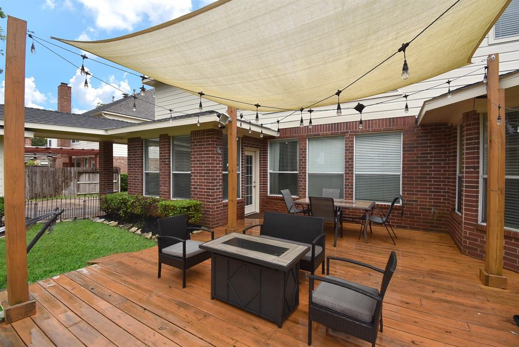 This covered patio seems made for family and friend hosting! And, while we\'re at it, one of the home\'s upgrades includes a new roof!