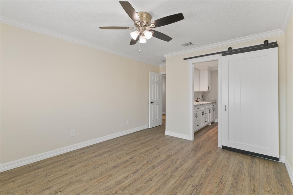 Primary suite with barn door to bath ~