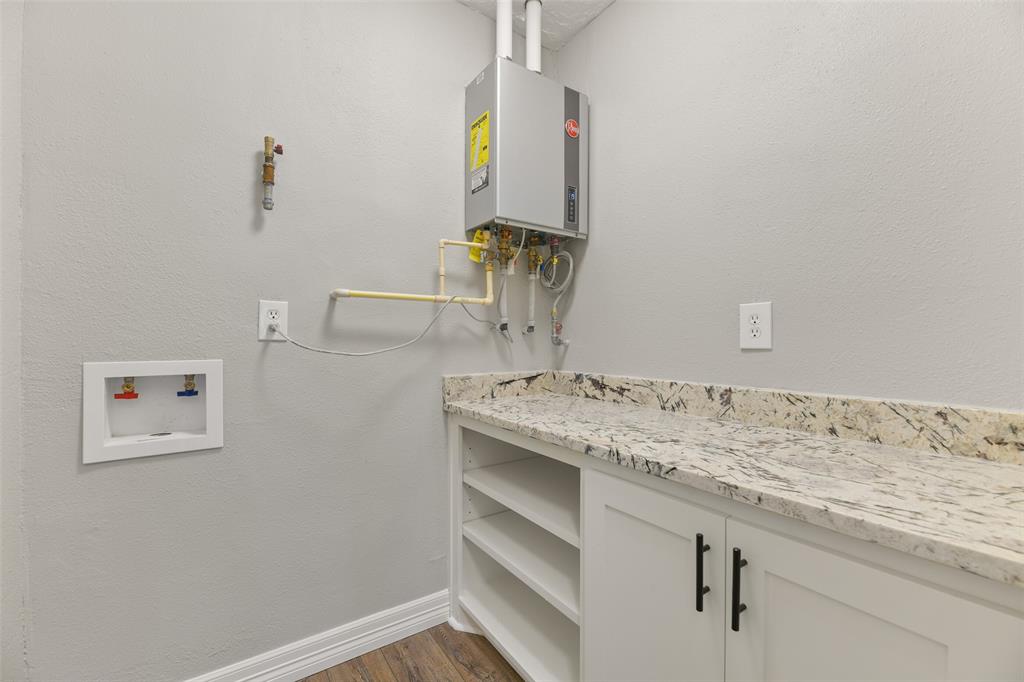 Utility room with storage space, folding area and tankless water heater ~