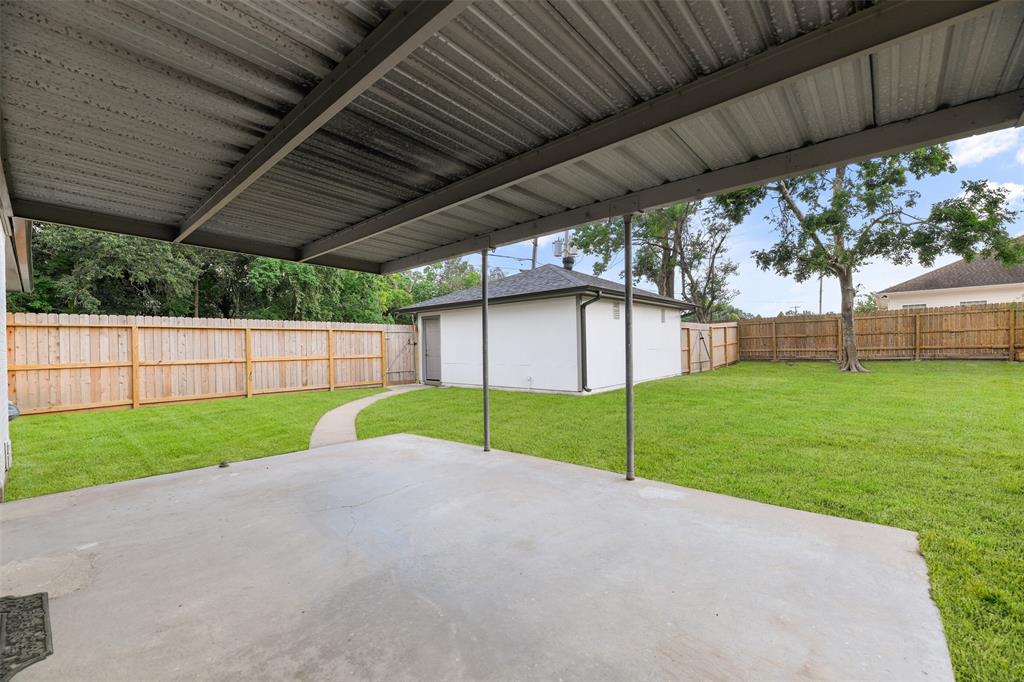 Covered backyard patio with new fencing ~