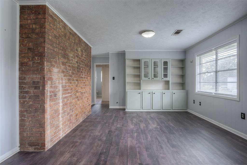 Back of brick fireplace faces the dining area