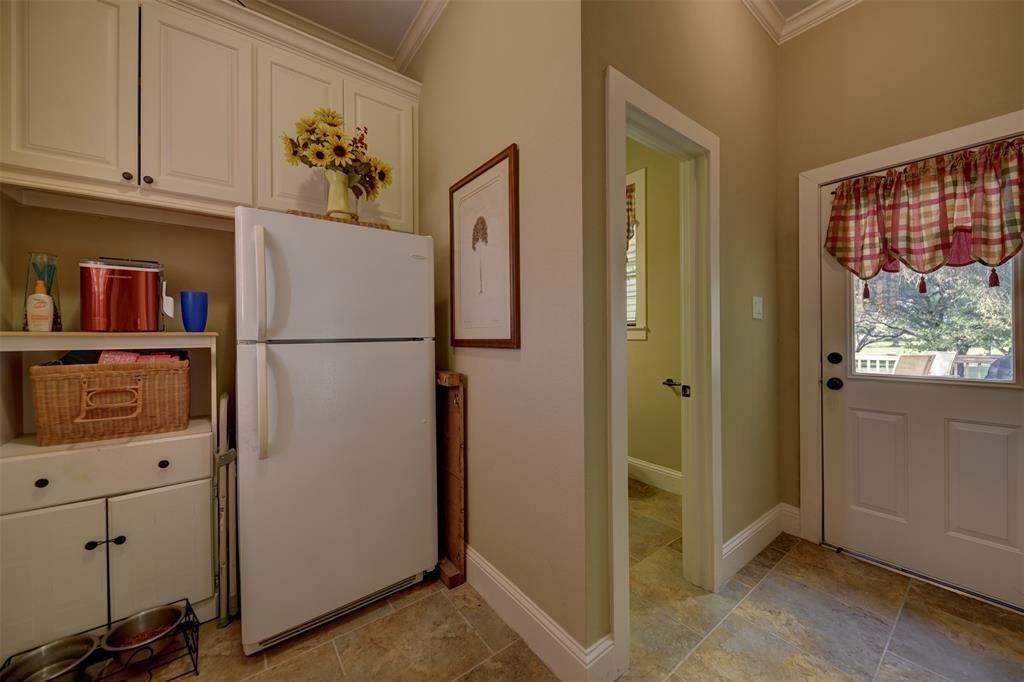 Mud room with door to the pool. There are washer dryer connections here as well.