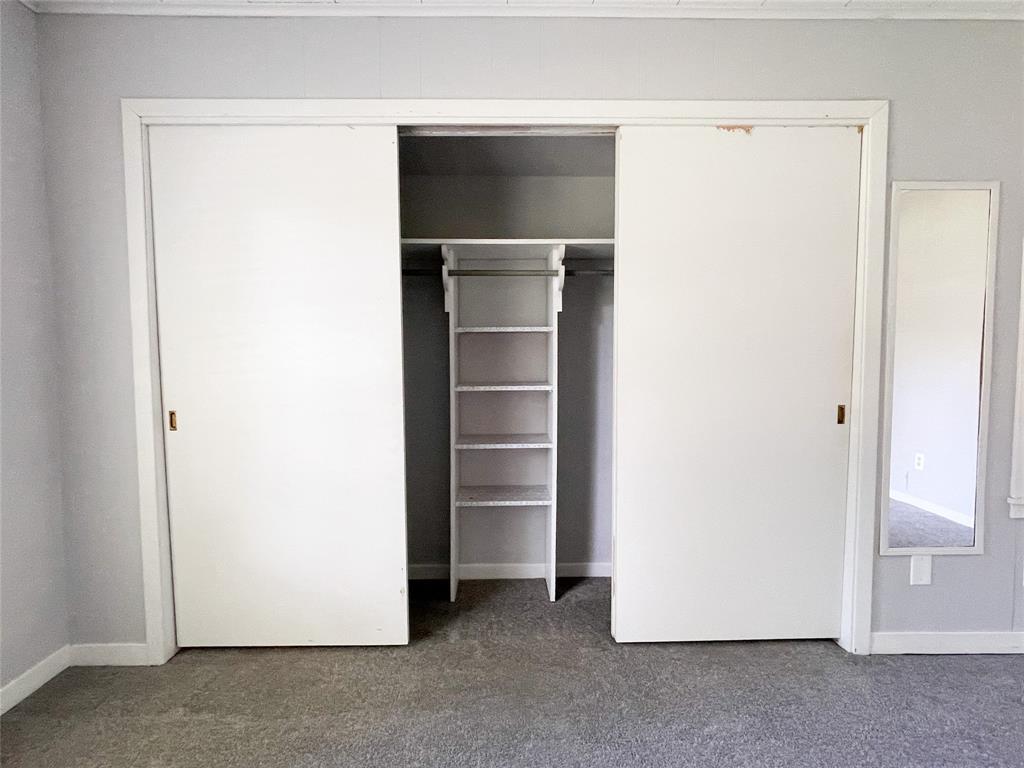 Closer view of Primary closet with built in shelving