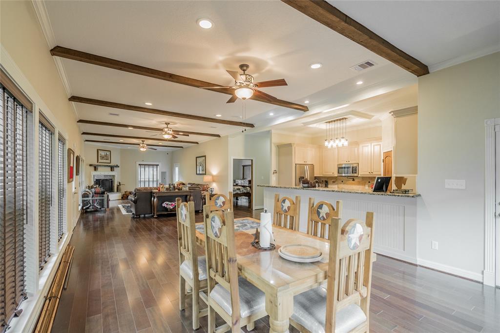 From this view, you can see this fabulous kitchen. It also is filled with light from the many windows and light fixtures in the home.  There are STARS every while. Notice the Stars in the ceiling fans, on the furniture, doors, fireplace and other spots throughout the home.  Notice the moldings on the ceiling and floors.