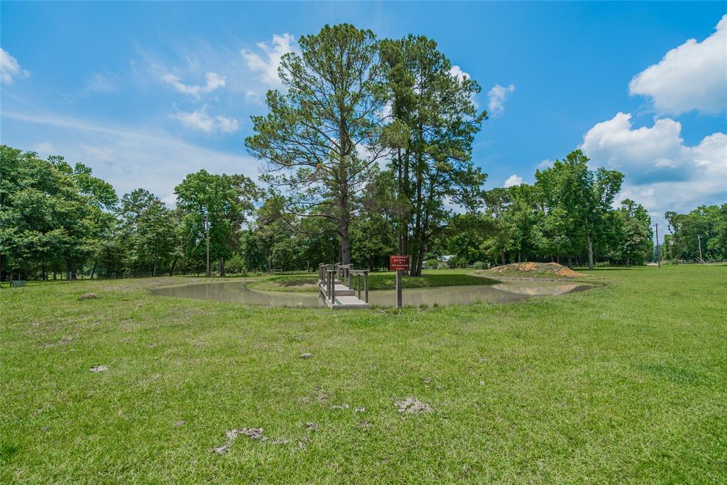 I loved this feature of the property. A pond built completely around a group of trees, and a really neat bridge going to the island. The pond is stocked with great fish and is 4\' deep on one side, and 8\' deep on the other. Your family and friends will have some Great Memories here.