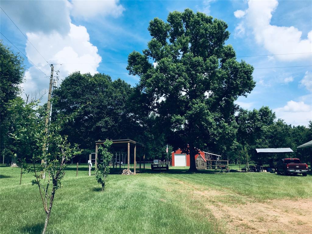 In the foreground, please notice the covered area that is fully wired, for a Large Motor Home. In the background, you will notice the Large Red Barn, which also will house a motor home, and all of your toys.