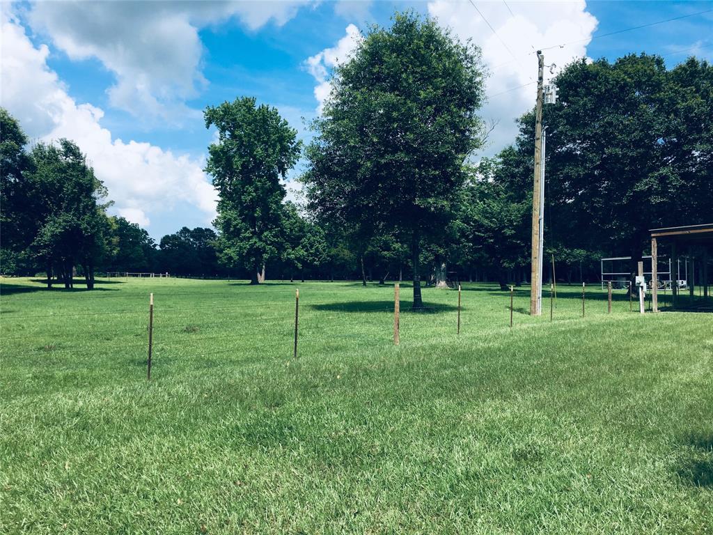 Property is fully fenced and cross fenced. There is a three car carport in the distance on the right side of the picture. Lots of room for Horses and Cows. Property backs up nearly to the National Forest. Talk about Hunting!!