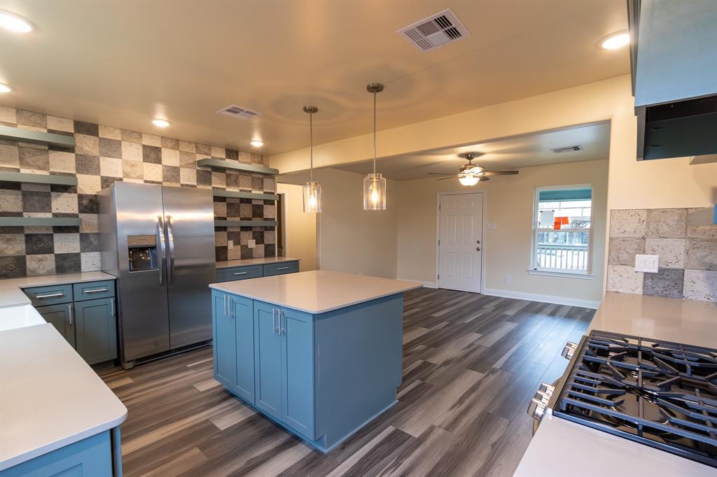 Quartz countertops, new beam added for additional support between kitchen and living