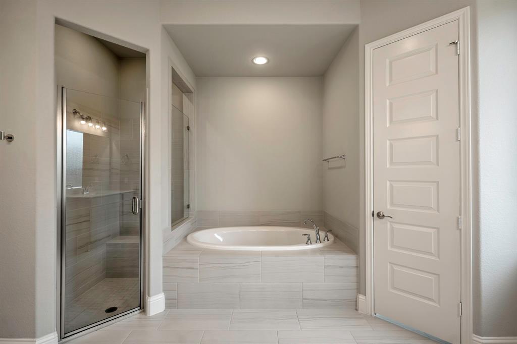 Another view of the open entry way showcasing the modern lighting and leading to the home office, media room, and secondary bedrooms!