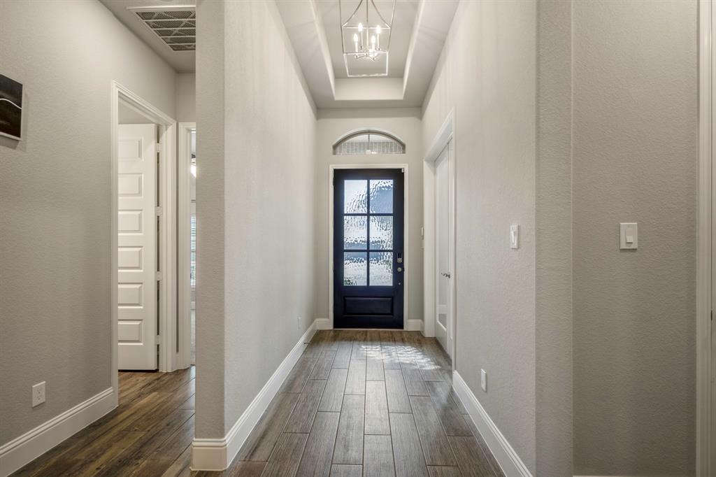 The study is quietly tucked away at the front of the home making it a peaceful space with serene views of the outdoors. It includes glass French doors, wood look flooring, and high ceilings!