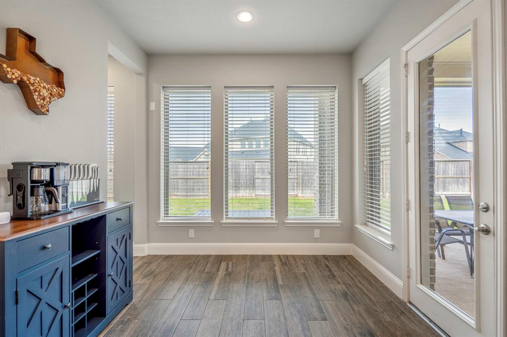 Gather the family and guests together in your huge living room! Featuring 12ft. high ceilings, a gas fireplace, ceiling fan, wood-tile flooring, and large windows that provide plenty of natural lighting throughout the day! *This photo has been virtually staged