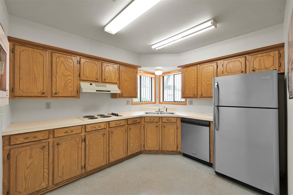 Kitchen with updated dishwasher and refrigerator stays.