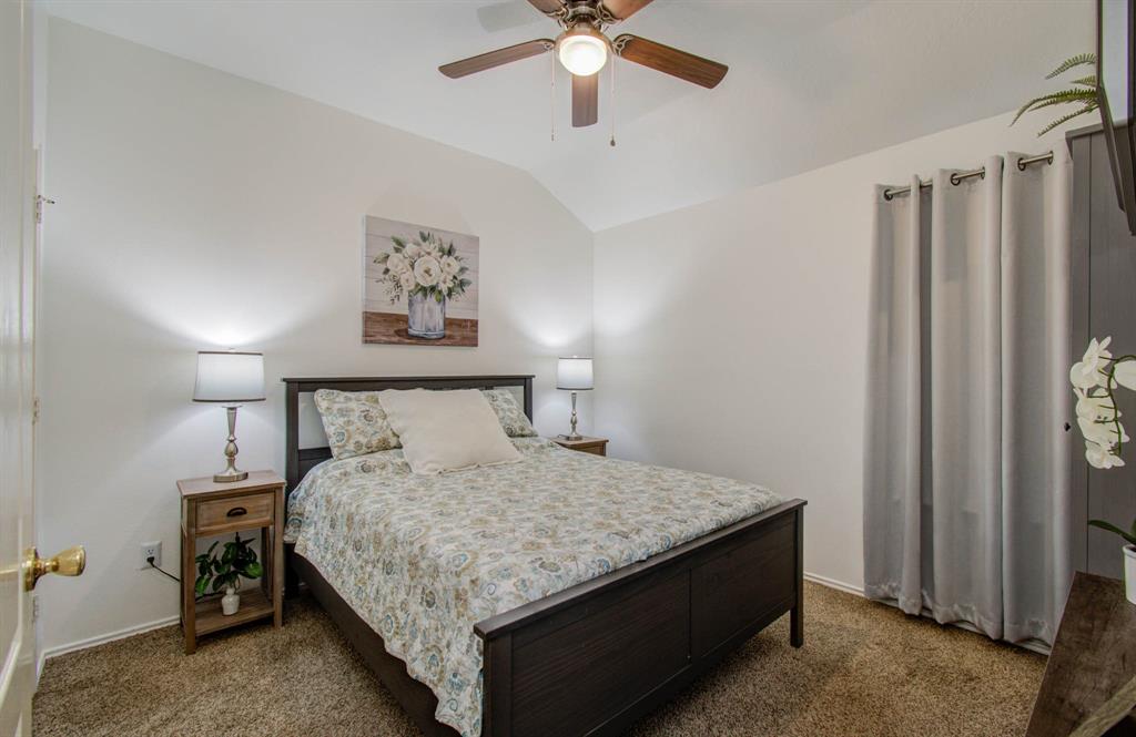 This cozy bedroom offers large windows and striking natural lighting