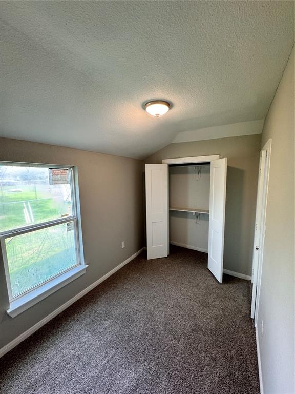 Second bedroom with closet storage area off the kitchen