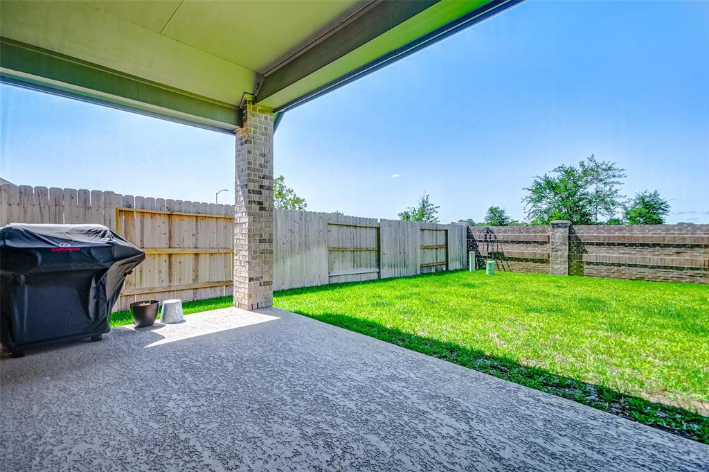 Oversized back patio with textured floor for another upscale look!