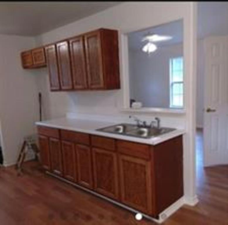 Kitchen view. breakfast bar over sink.