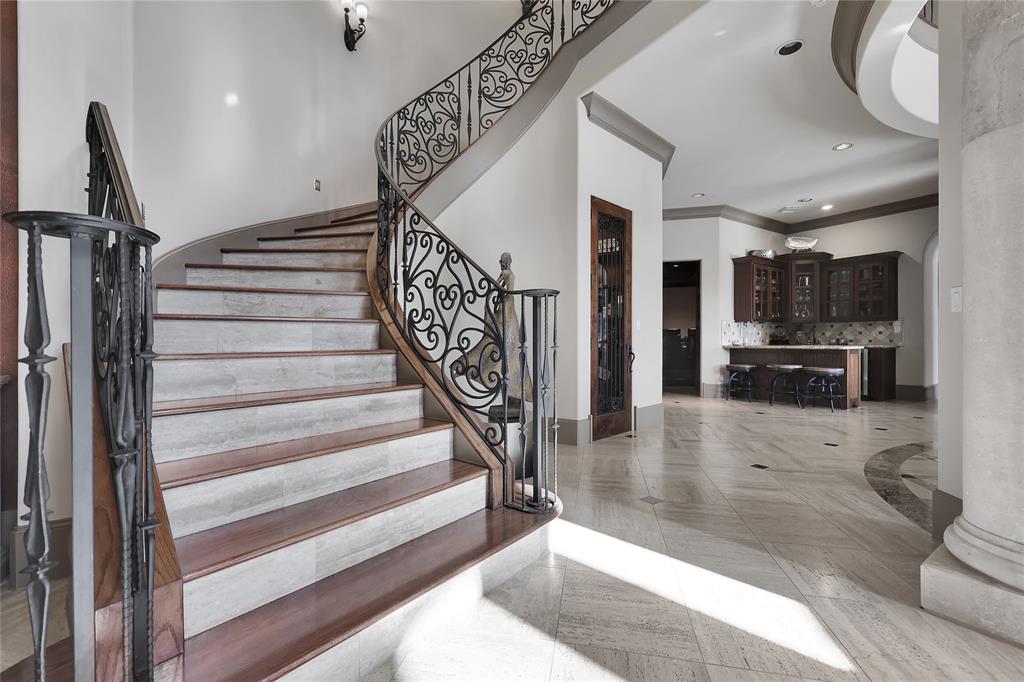 Spectacular Winding Staircase with Stone and Wood stairs leading to the upstairs living spaces as well as first level ones .