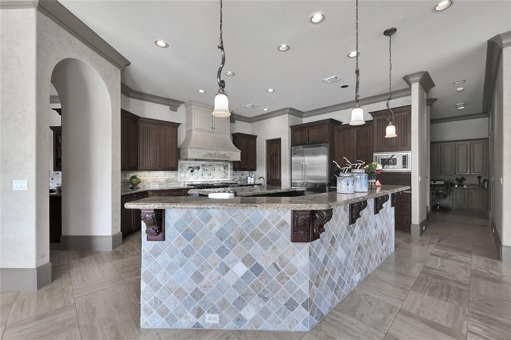 Alternate view of the Gourmet Kitchen with Breakfast Bar for more seating and space and an open concept to allow for ease of conversation from one area to the next.